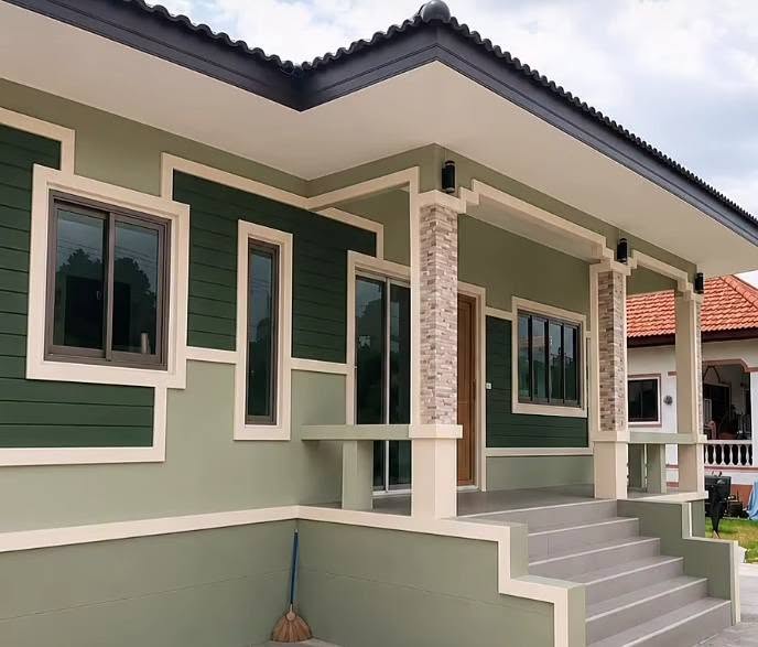 Deep green residential exterior with cream trim