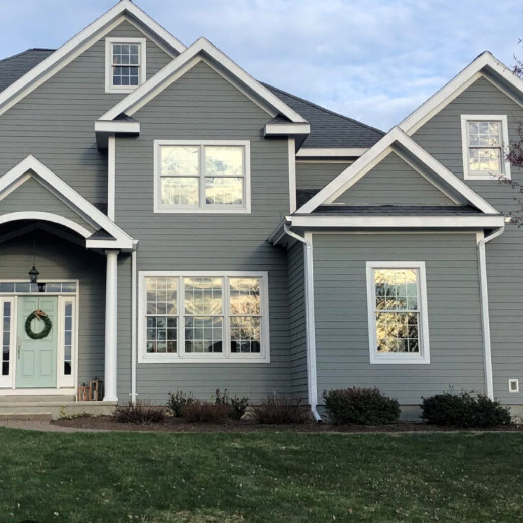 Modern grey two-storey residential exterior with white trim